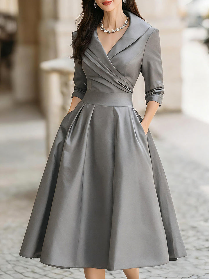 Female model wearing a dressy midi outfit with side pocket detail on a plain background.