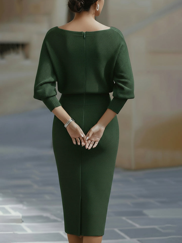 Woman wearing a white formal midi dress with long sleeves on a plain background.