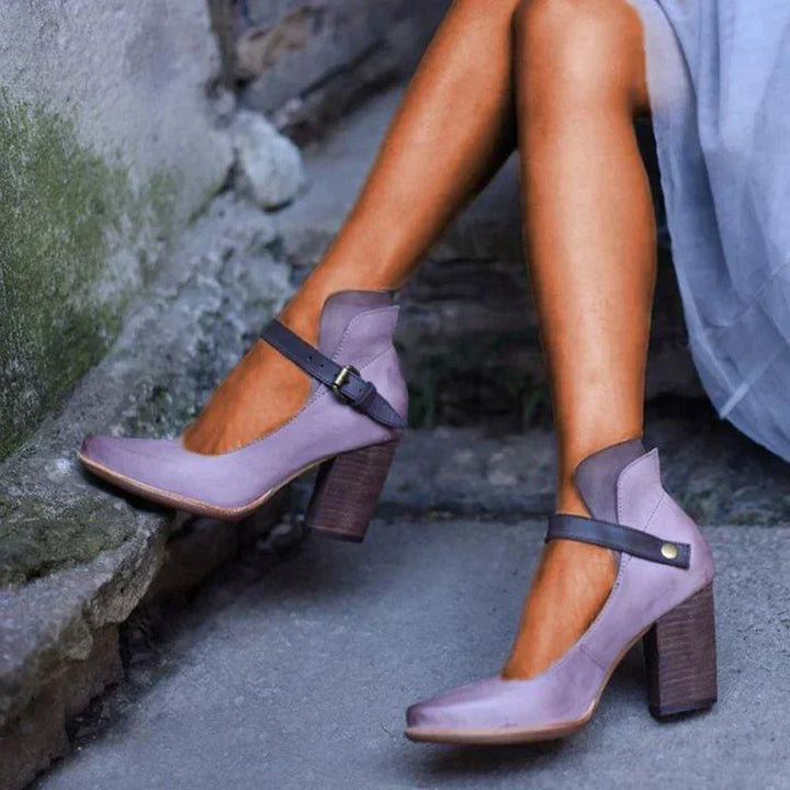 Female wearing elegant heel sandals on a plain background.