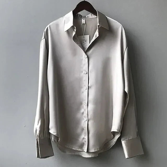 Long-sleeve satin blouse with a tailored silhouette..