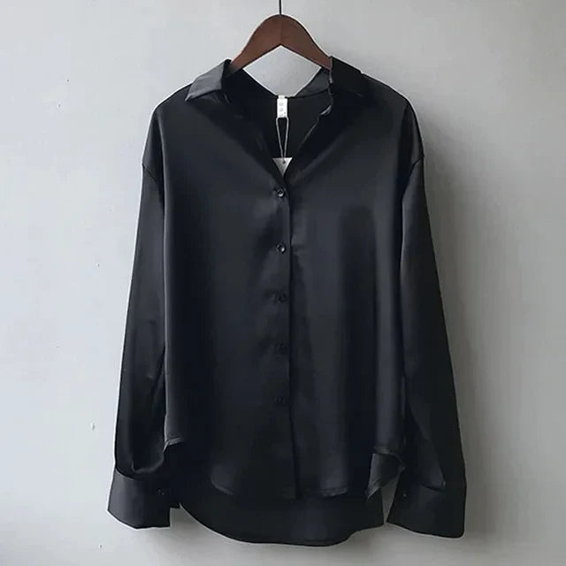 An elegant button-down blouse with a soft satin finish  