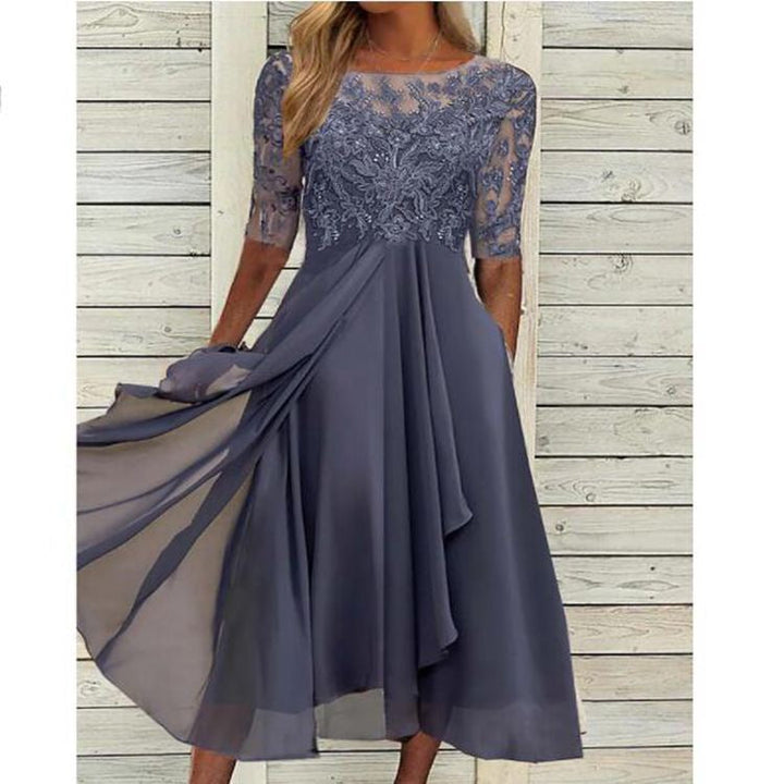 Model wearing a feminine formal dress with lace detail on a plain background.