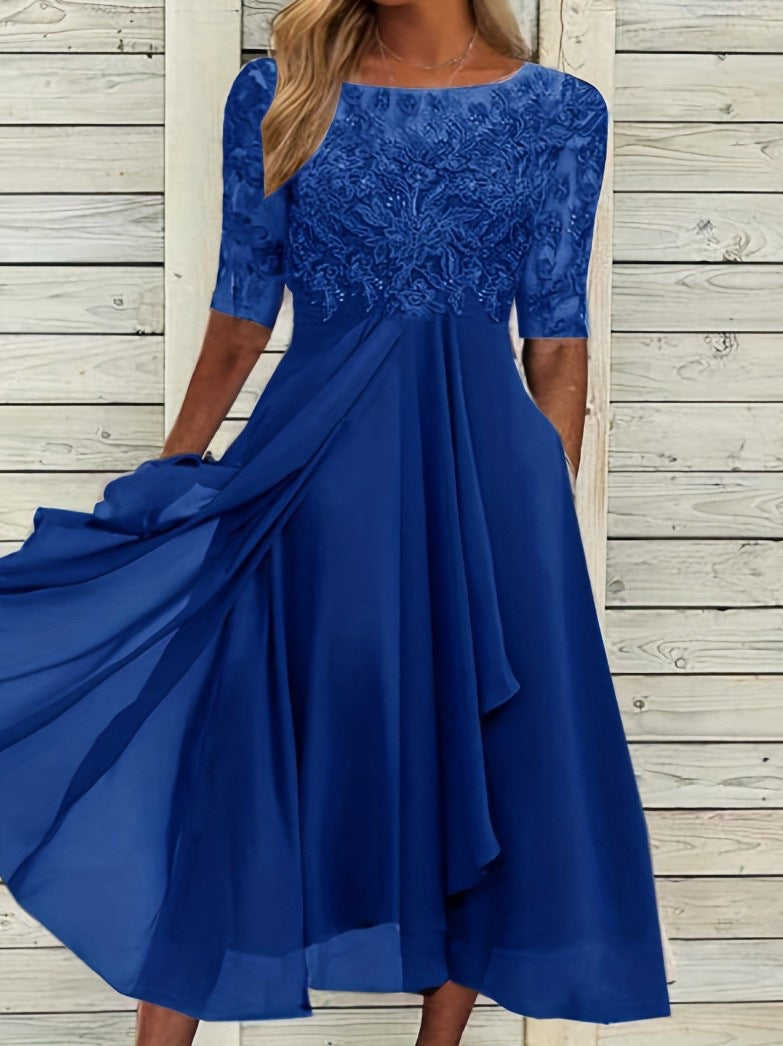 Female model in an elegant ankle-length dress for special occasions on a plain background.