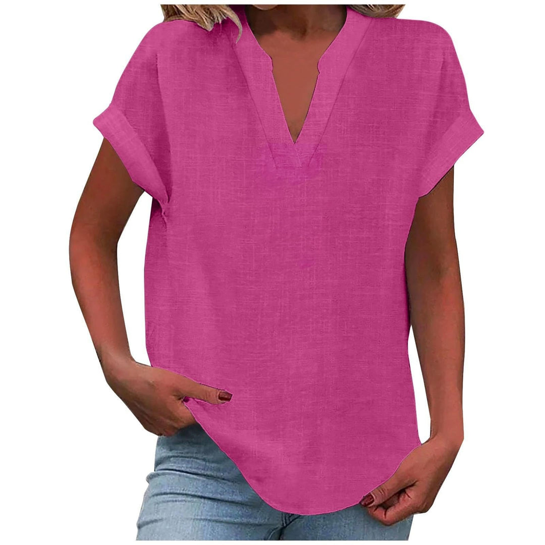 Female wearing a relaxed short-sleeve blouse against a plain background.