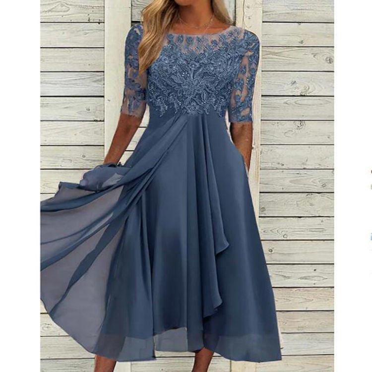 Woman wearing a bridesmaid-style dress with lace bodice on a plain background.