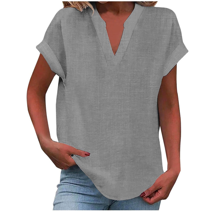  Woman modelling a relaxed everyday blouse against a plain background.