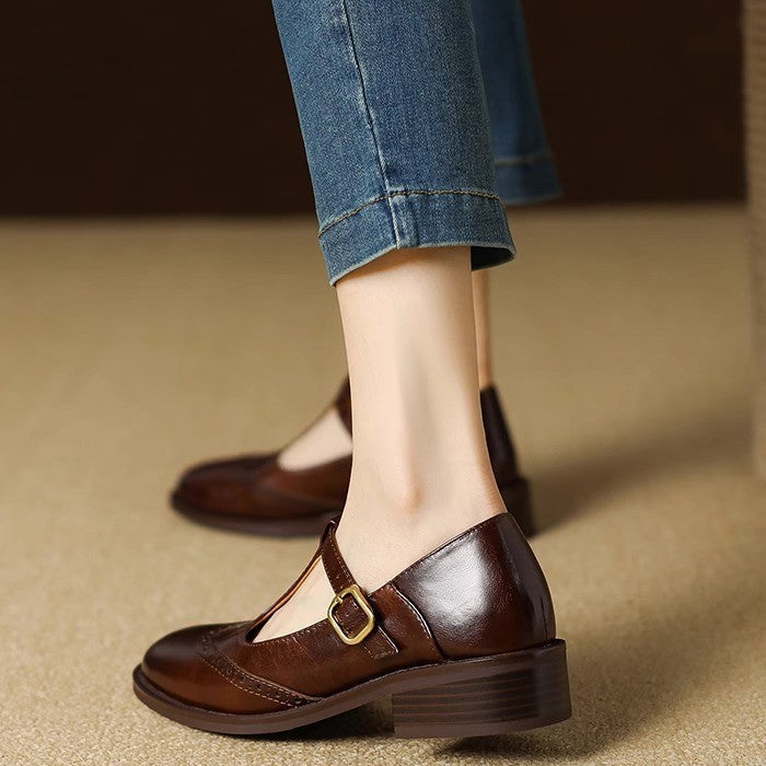 Classic Mary Jane shoe with decorative perforations on a plain background.