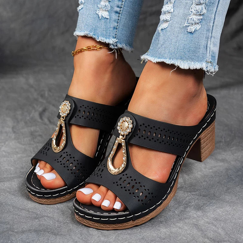 Female model wearing stylish wedge sandals on a plain background.