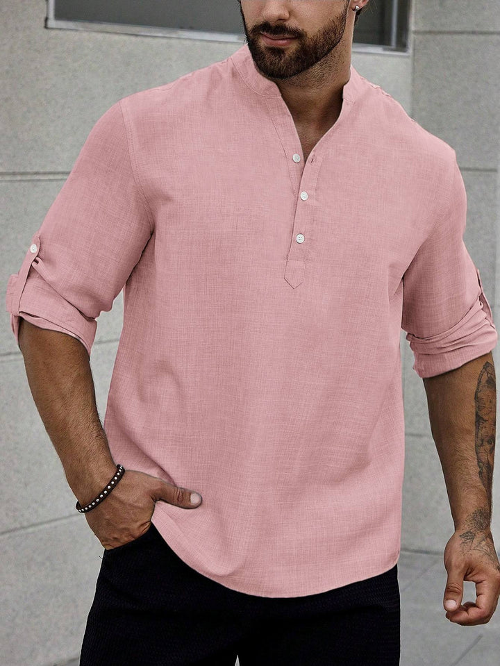 Man styling a slim fit button-up shirt for everyday wear.