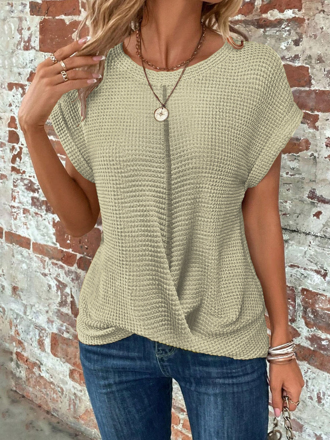 Female modelling a casual top with textured detailing and rolled sleeves.