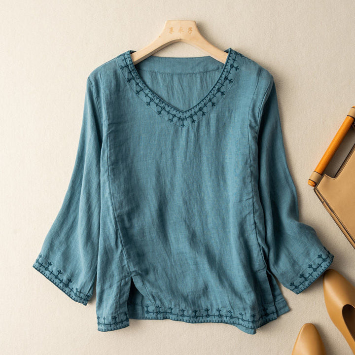 A flowing long sleeve blouse with embroidered accents.