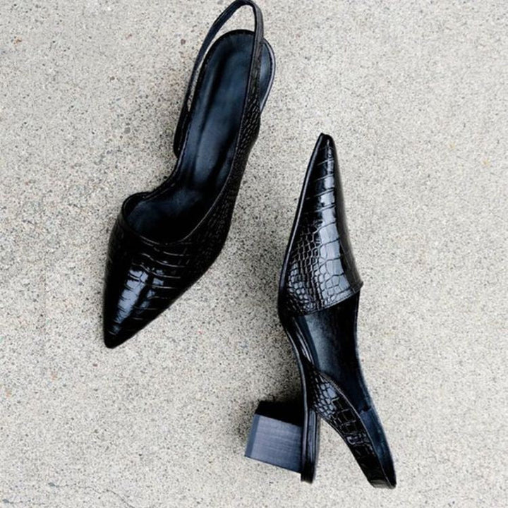 Chic heeled shoes on a plain background.