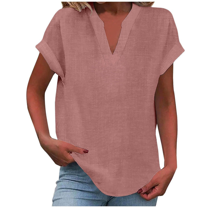  Female modelling a casual blouse with rolled short sleeves on a plain background.