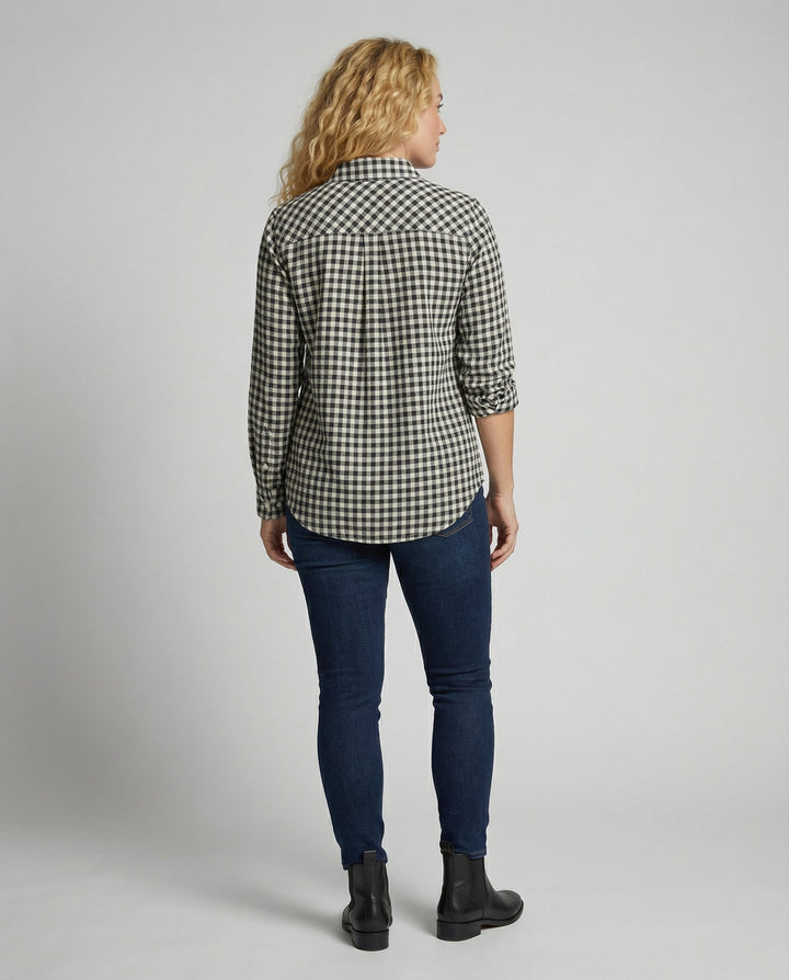 Woman in a mid-length check pattern shirt with button sleeve details.
