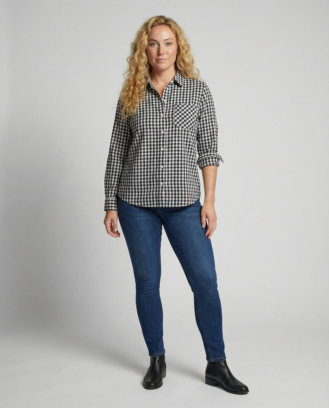 Female modelling a long sleeve checked blouse with a relaxed fit.