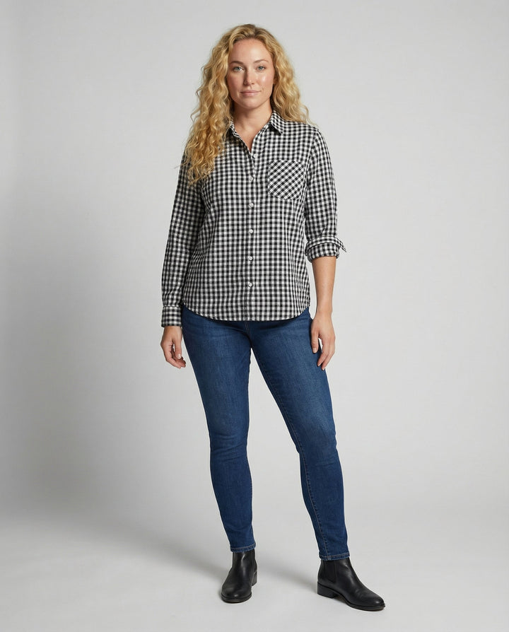 Female modelling a long sleeve checked blouse with a relaxed fit.