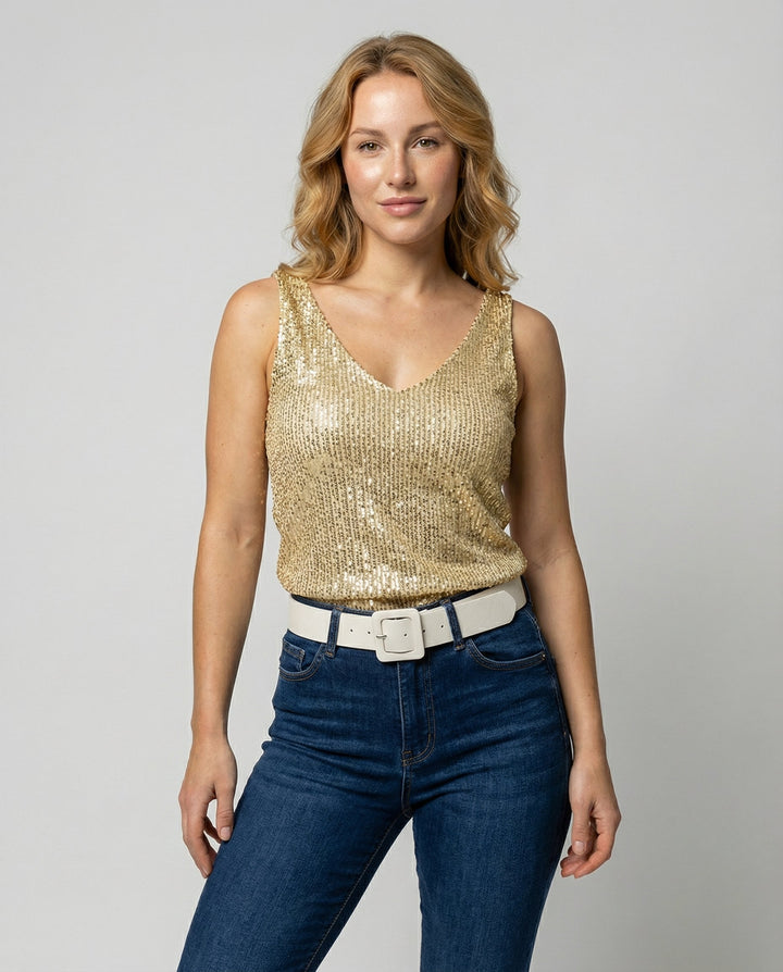 Woman wearing a sequin V-neck top against a plain background.