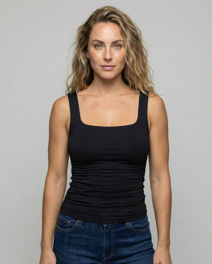 Woman wearing a square neck fitted top against a plain background.