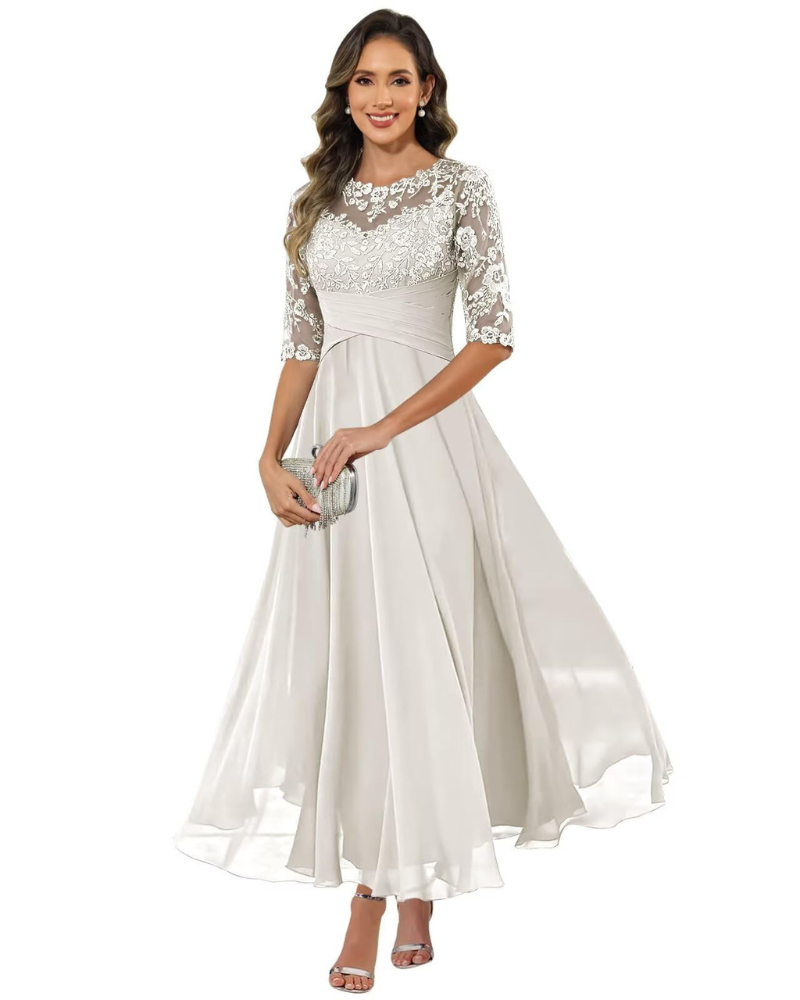Model in a flowing chiffon style dress for occasions on a plain background.