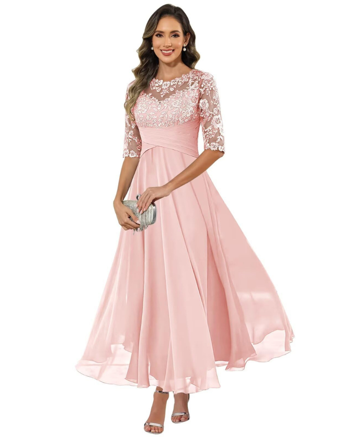 Woman in a graceful evening outfit with long skirt on a plain background.