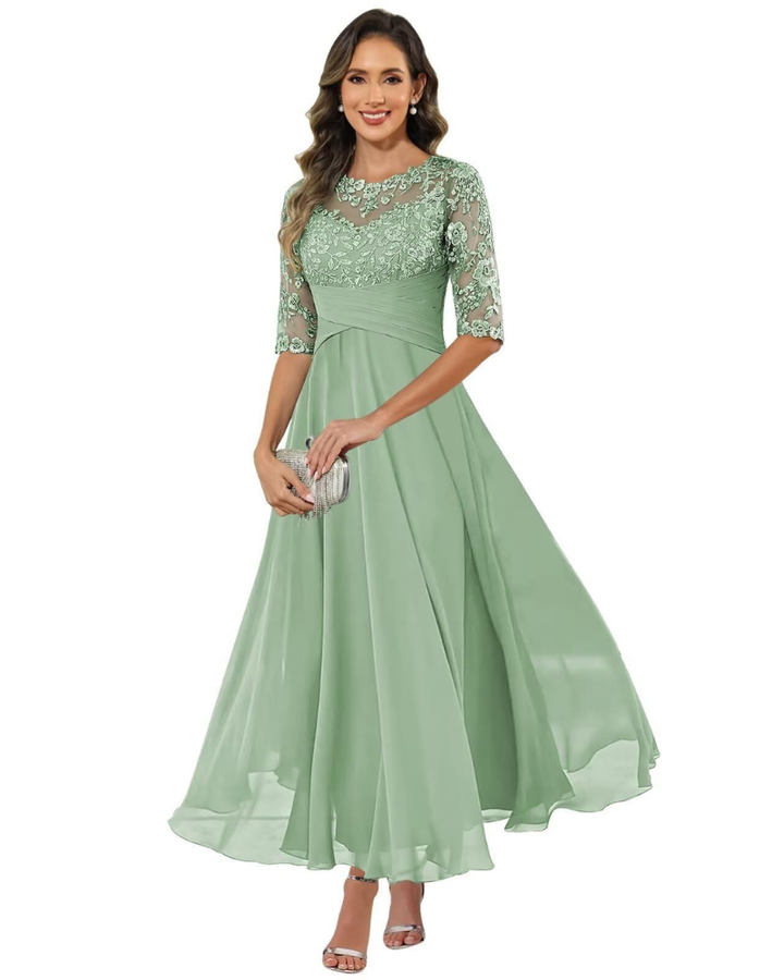 Female model in a formal A-line dress with lace accents on a plain background.