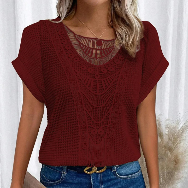 Woman wearing a stylish lace detail top for everyday dressing.