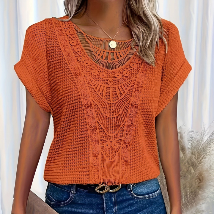  Female wearing a casual lace top with a clean and feminine design.