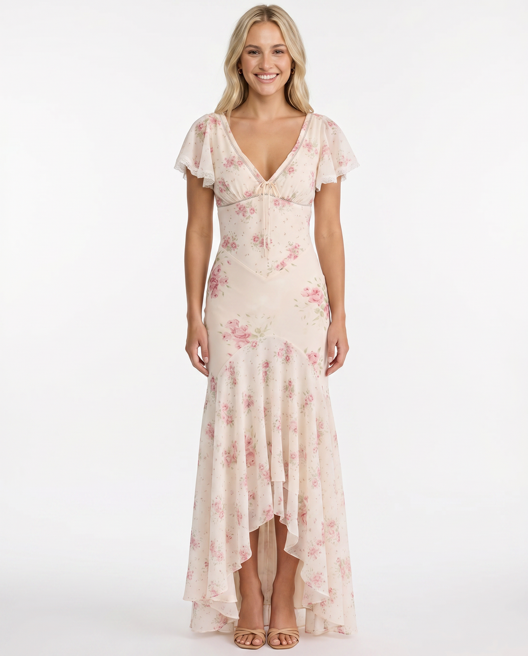 Female wearing a summer dress with an all-over floral pattern against a plain background.