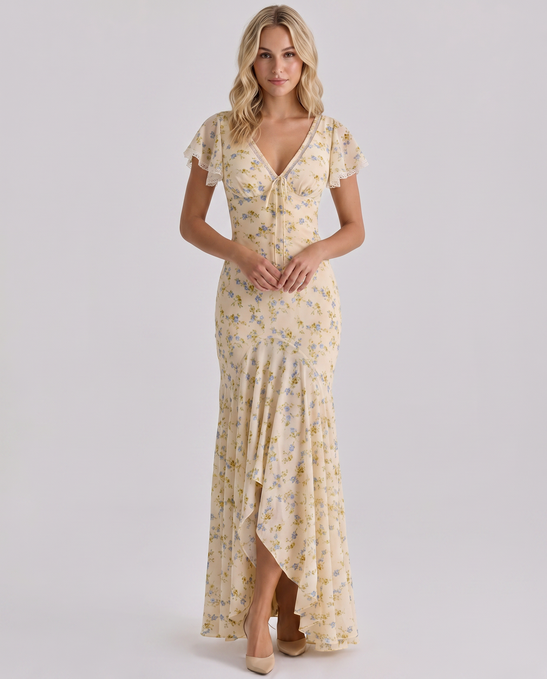 Woman modelling a flowing floral dress designed for warm-weather wear.
