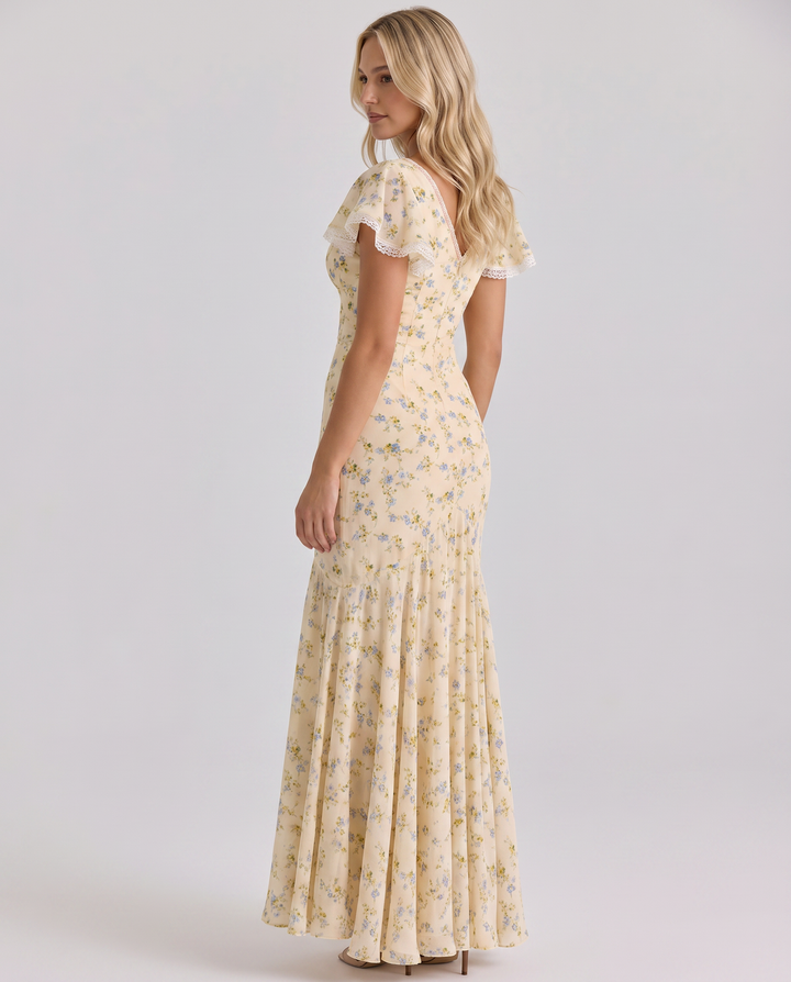 Woman wearing a floral dress with a breezy fit on a plain background.