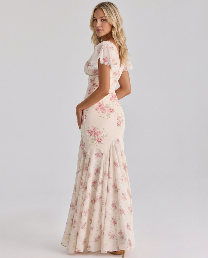  Woman in a floral midi dress featuring a relaxed and airy shape.