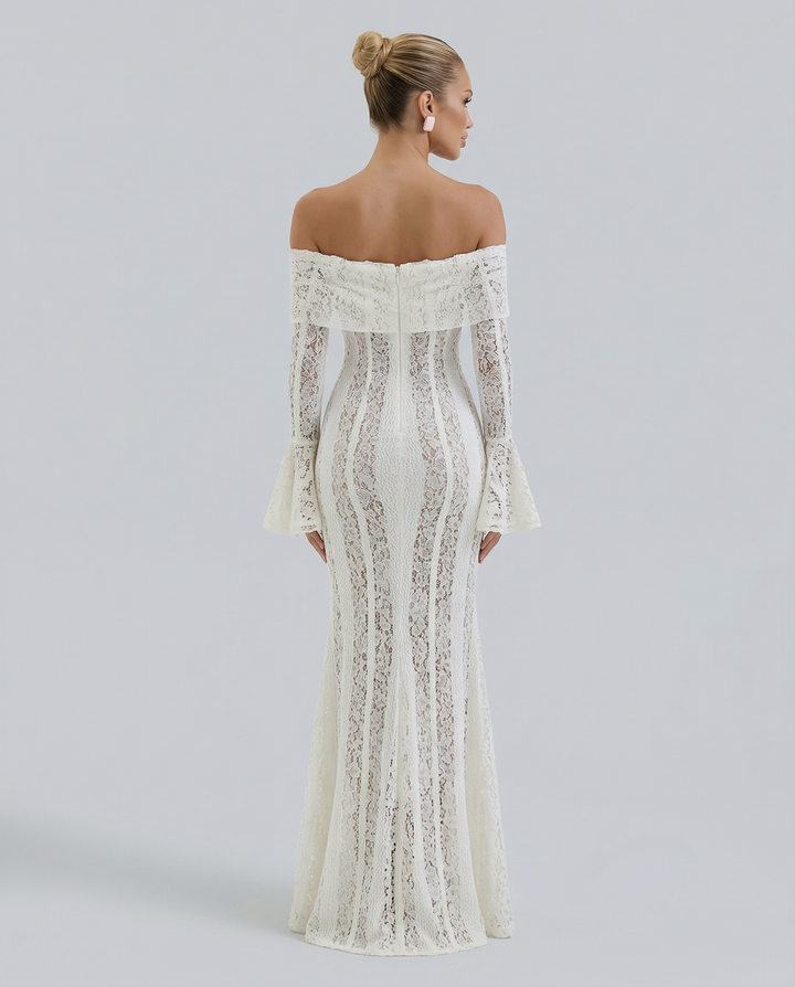 Female modelling a fitted lace maxi dress with a softly flared hem.