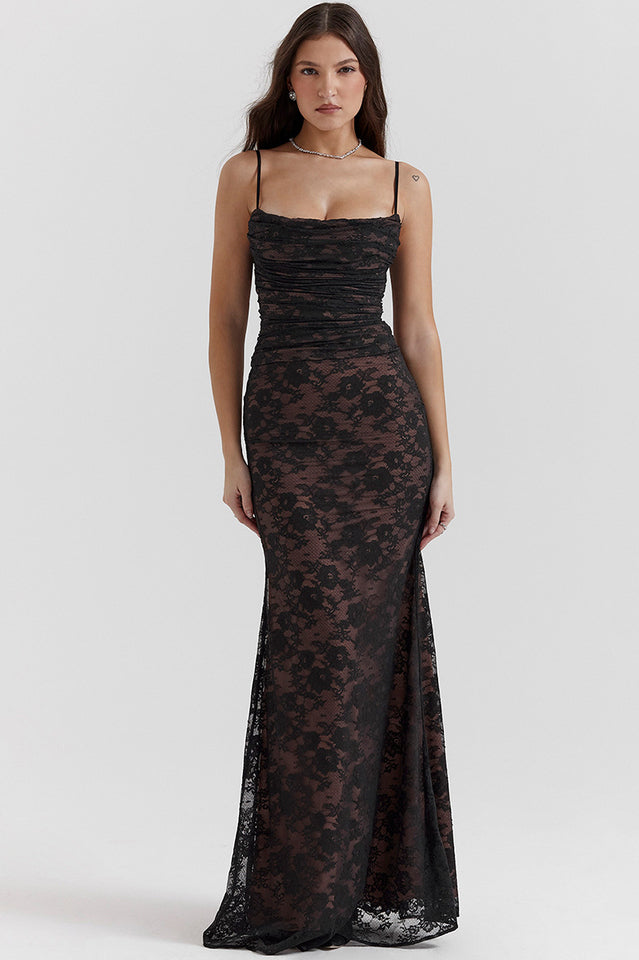 Woman wearing a lace maxi dress with a straight neckline and body-contouring shape.