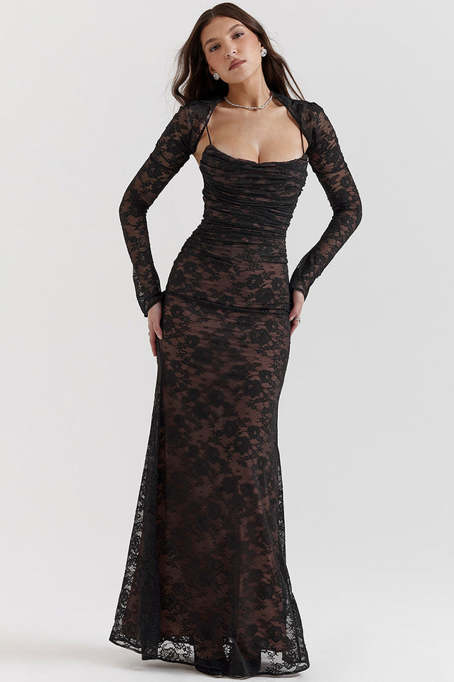 Female in a fitted maxi dress featuring delicate lace detailing and sheer sleeves.