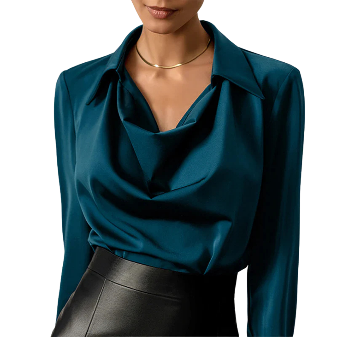 Woman wearing a long sleeve satin blouse with a draped neckline on a plain background.