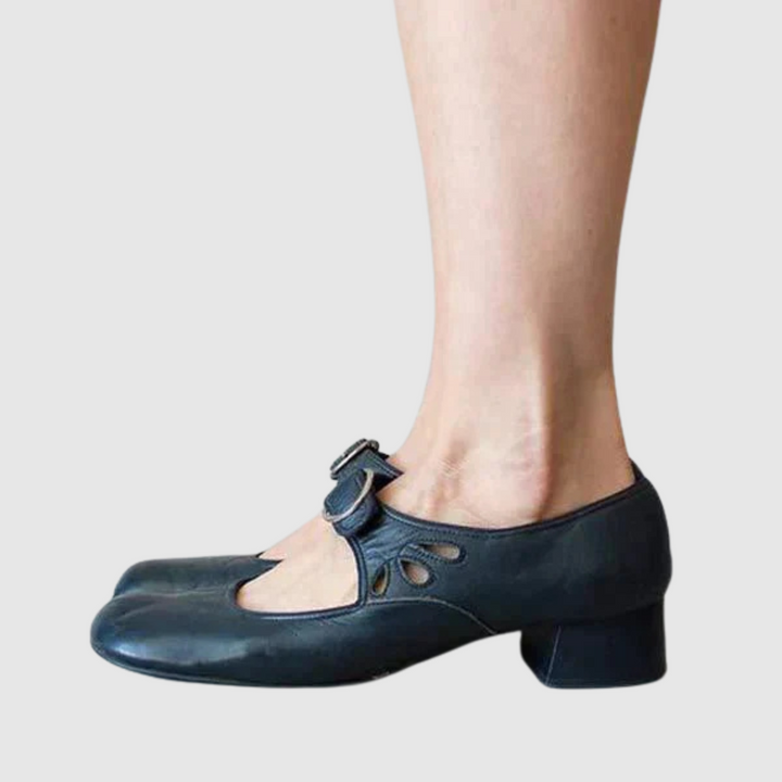 Female model standing in versatile shoes against a plain background.