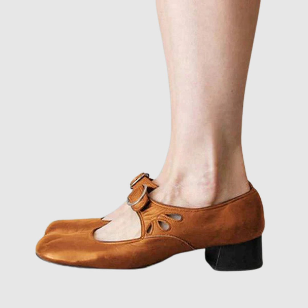 Woman showing timeless everyday shoes with a plain background.