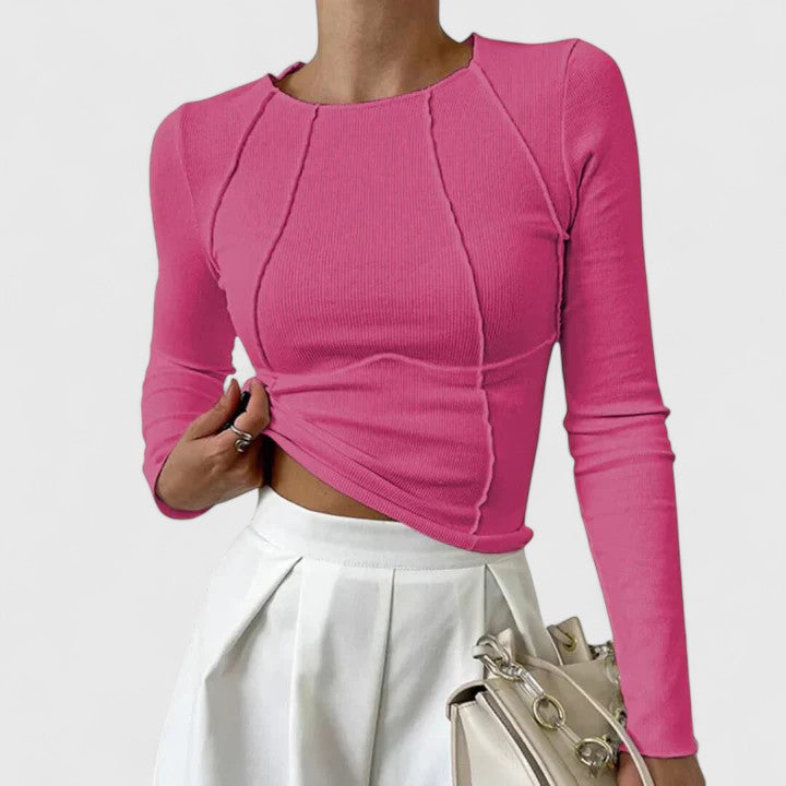 Female model wearing a versatile women’s top on a plain background.