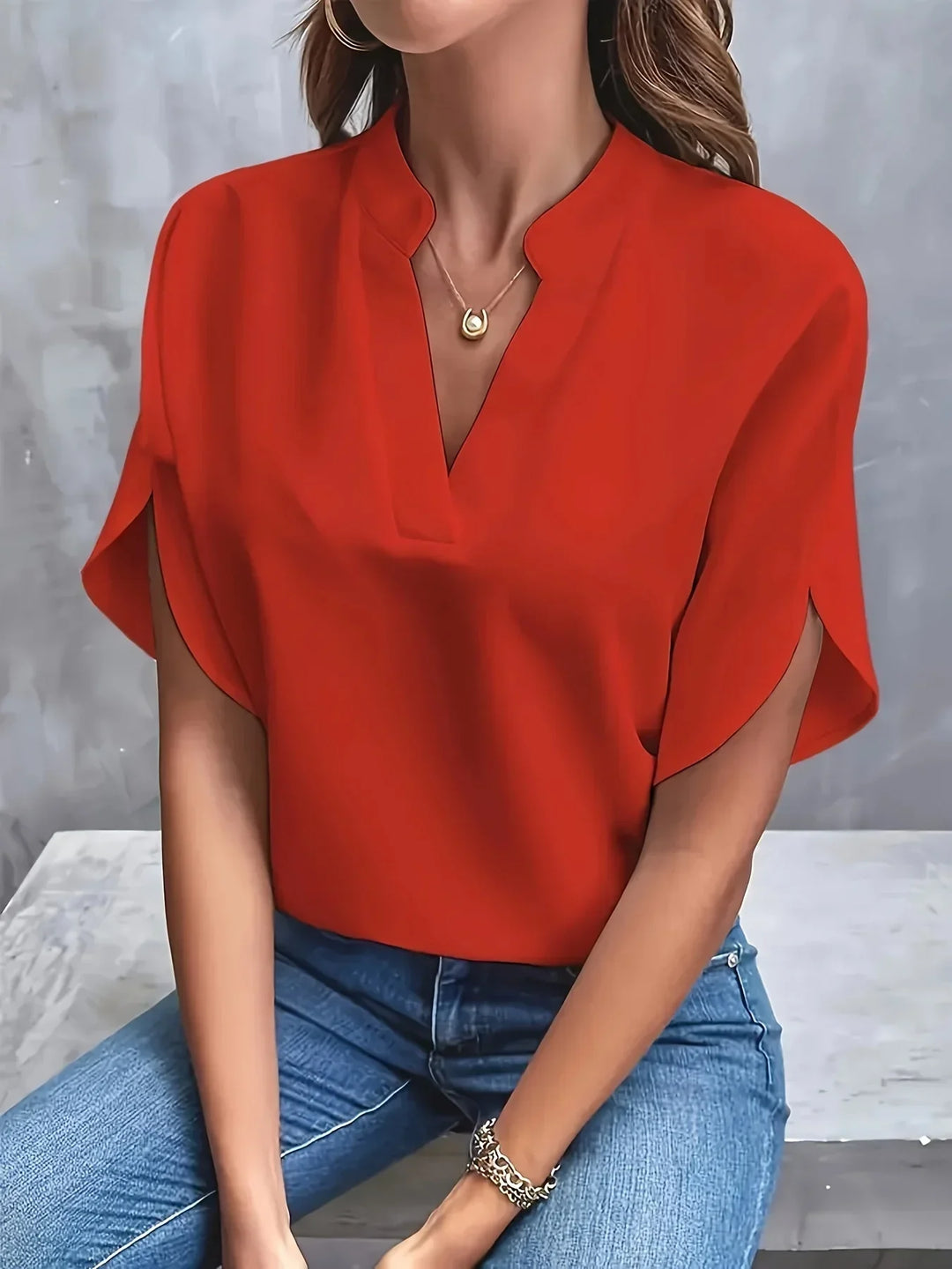  Woman modelling a casual V-neck top with a flowing silhouette.