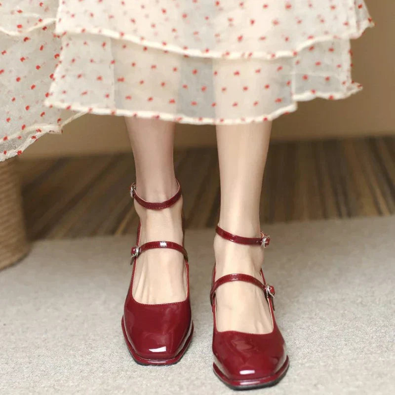Woman styling black block heel pumps with a simple outfit on a plain background.
