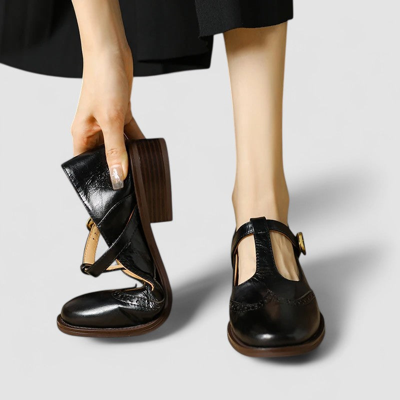 Classic Mary Jane flats on a plain background with a rounded front.