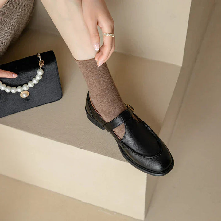 Female wearing vintage inspired Mary Jane shoes with a low block heel on a plain background.