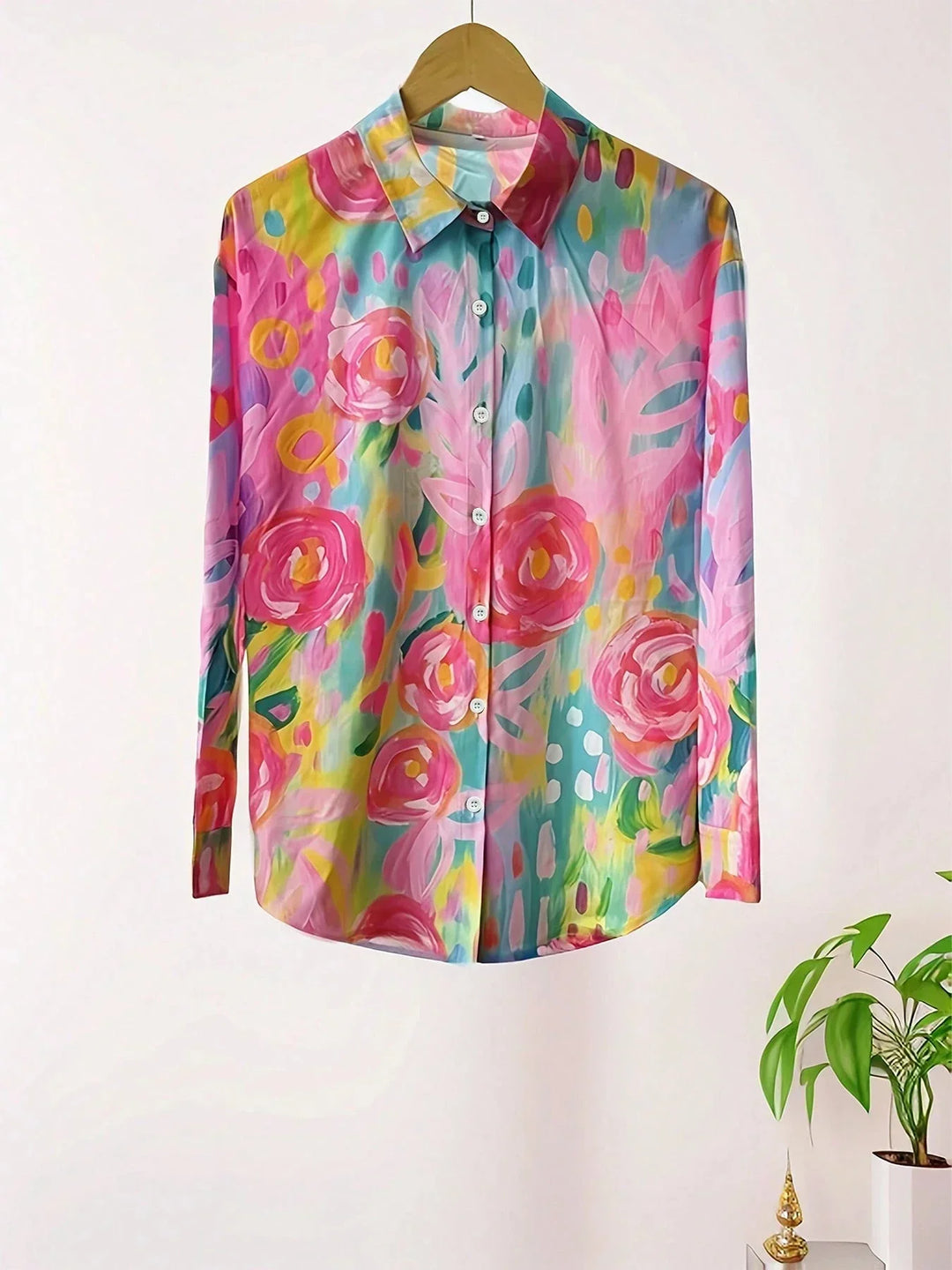 Casual floral blouse paired for warm-weather fashion on a plain background.