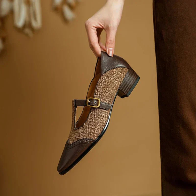 Two-tone Mary Jane shoes with buckle fastening on a plain background.