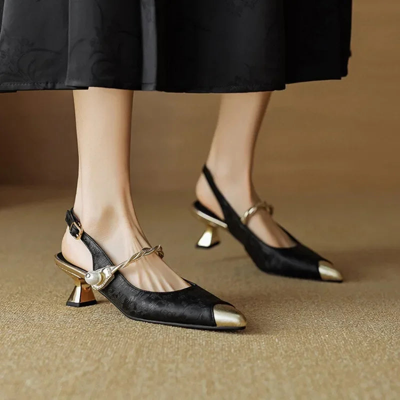 Feminine occasion heel with floral texture and polished metallic accents.