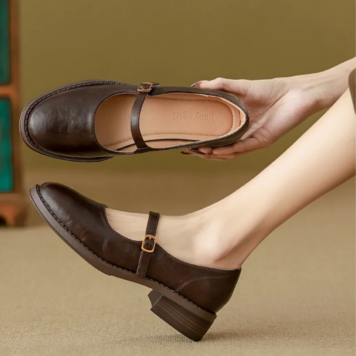 Leather-look dress shoes displayed on a plain background with a low block heel.
