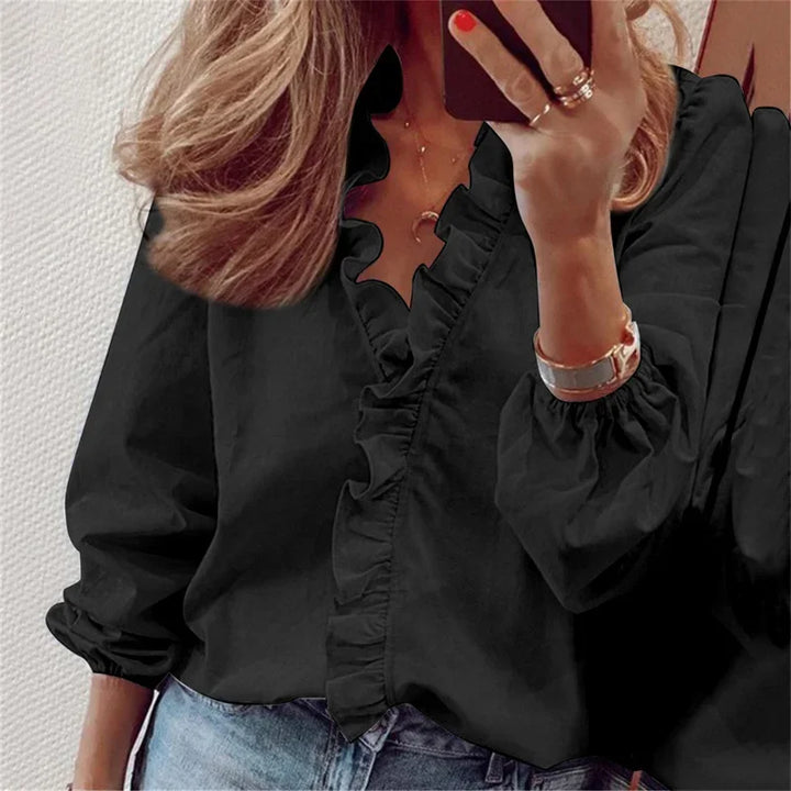  Female wearing a stylish long sleeve blouse with soft draped shaping.