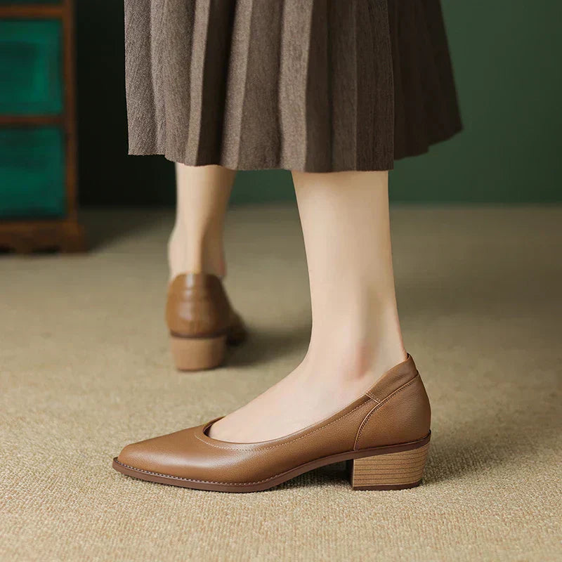 Women’s mid-height block heel pumps shown on a plain background.