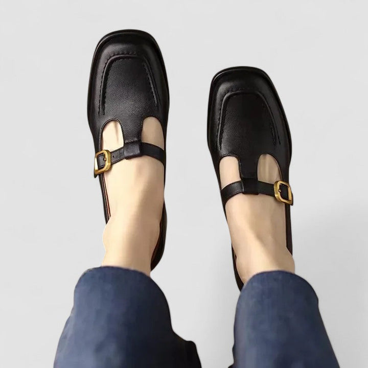 Female Mary Jane shoes shown on a plain background with rounded toe styling.