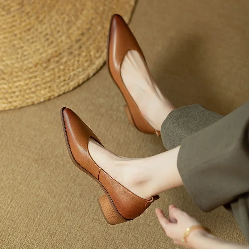 Female wearing elegant everyday pumps against a plain background.